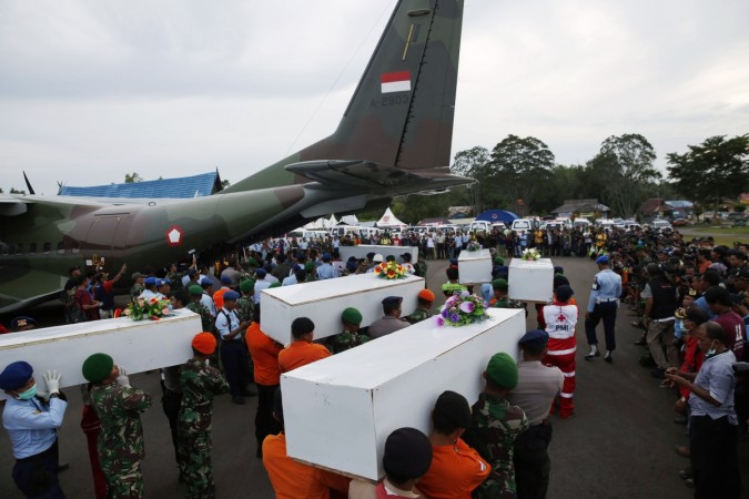 Caskets containing the remains of AirAsia QZ8501 passengers recovered from the sea are carried to a military transport plane before being transported to Surabaya, where the flight originated, at the airport in Pangkalan Bun, Central Kalimantan January 2, 2015. Ice caused AirAsia QZ8501 flight crash.