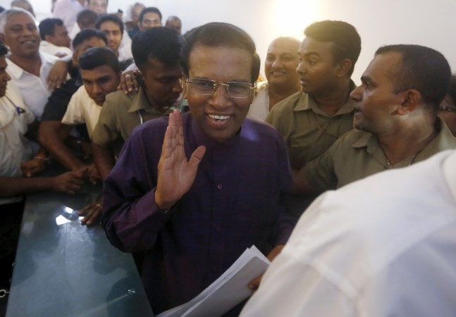 Sri Lanka's new executive president Mithripala Sirisena waves to the media as he leaves the opposition party office in Colombo on 9 January 2015. Sri Lanka president Mithripala Sirisena