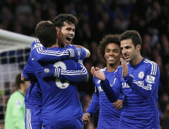 Chelsea's Diego Costa (back) embraces teammate Oscar as they celebrate his goal during their English Premier League match against Newcastle United at Stamford Bridge Chelsea