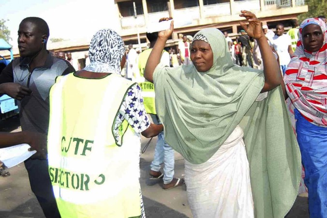 Displaced people fleeing from violence are screened by a Joint Task Force officer at the camp for displaced people in Borno state January 19, 2015. Displaced Nigerians fleeing from Boko Haram