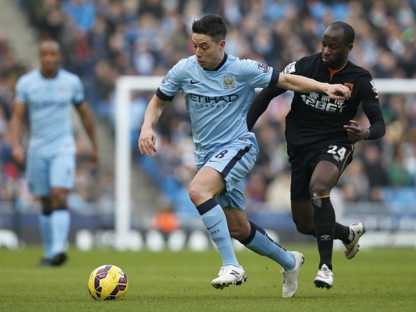 Samir Nasri of Manchester City evades Sone Aluko of Hull City during their English Premier League match at the Etihad Stadium Samir Nasri