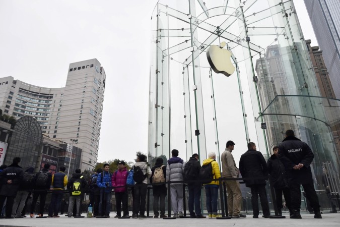 Customers queue to wait for the opening of a new Apple Store in Chongqing municipality, January 31, 2015. The store is the second in the city and the fifteenth in mainland China, local media reported. Apple Inc is steering clear of Chinese rival Xiaomi Inc's low-price online strategy, ramping up store openings in China to harness its premium edge and fend off the fast-growing No.3 global smartphone maker. Apple Store in China