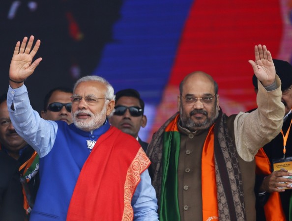 Narendra Modi(L) and Amit Shah(R) wave to their supporters during a campaign rally Amit Shah, Narendra Modi