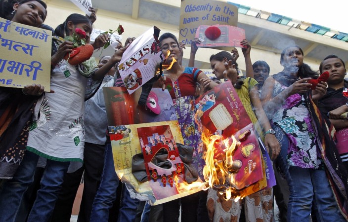 School students burn greeting cards during a protest against Valentine's Day celebrations in Ahmedabad on February 13 2013. Valentine's Day
