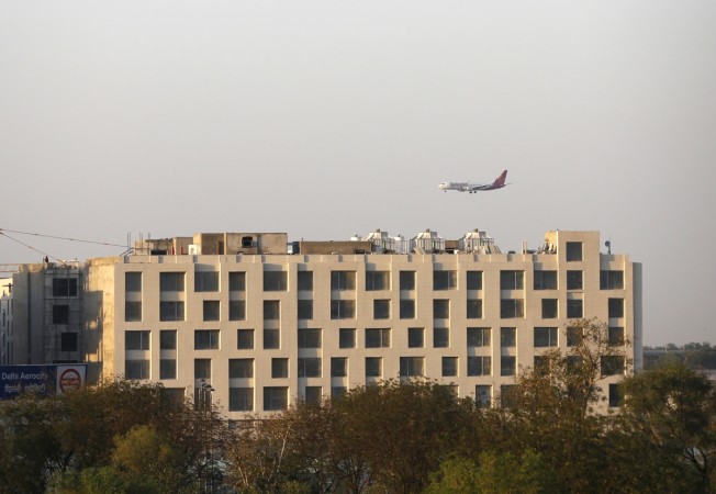 A SpiceJet Airlines aircraft flies past newly-constructed hotels on the way to landing at the Indira Gandhi International Airport in New Delhi April 1, 2013. SpiceJet Airlines
