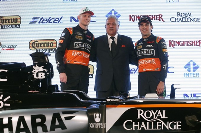 Force India Formula One drivers, Nico Hulkenberg of Germany (L) and Sergio Perez of Mexico (R), and Force India team principal Vijay Mallya pose with the new Force India racing car during its presentation at Soumaya museum in Mexico City on 21 January Force India