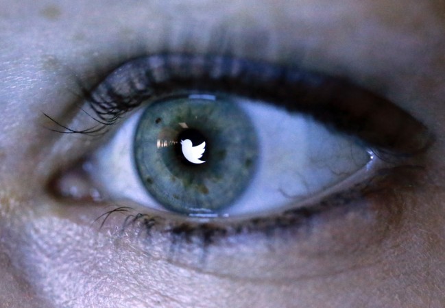 An illustration picture shows the Twitter logo reflected in the eye of a woman. Eye donation