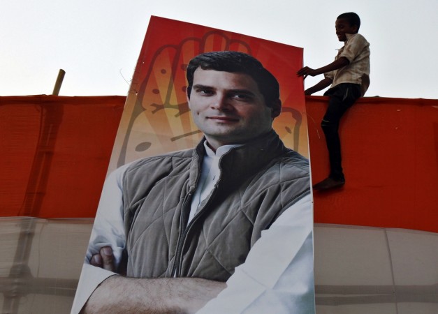 A boy holds a poster of Rahul Gandhi after an election campaign rally in Kolkata on 8 May, 2014. Rahul Gandhi