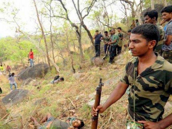 People gather at the site where the smugglers of red sanders -an expensive wood used in aphrodisiac drugs and to make musical instruments - were gunned down by police in Andhra Pradesh's Chittoor district on April 7, 2015. andhra pradesh encounter
