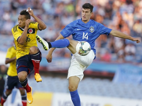 Brazil midfielder Nathan (right) clears the ball under pressure from Colombia's Jarlan Junior Barrera (L) during their match for the final round of the South American Under-20 Championship in Montevideo Nathan
