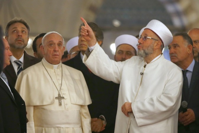 Pope Francis listens to Rahmi Yaran, Mufti of Istanbul (right) during a visit to Hagia Sophia in Istanbul