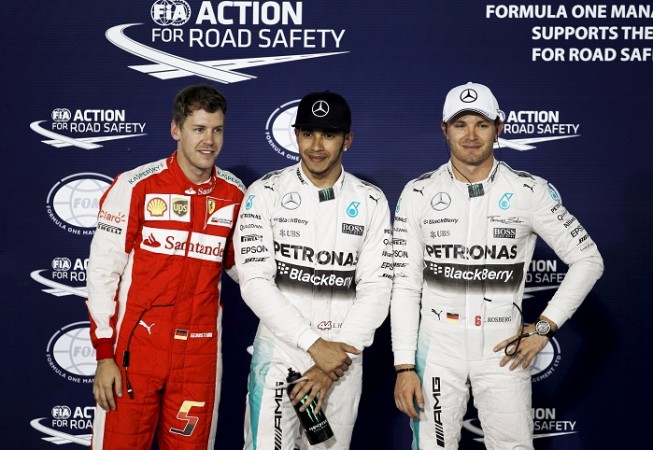 Mercedes driver Lewis Hamilton (C) poses with Ferrari's Sebastian Vettel (L) and teammate Nico Rosberg after securing the pole position in Saturday's qualifying in Bahrain. Bahrain Grand Prix
