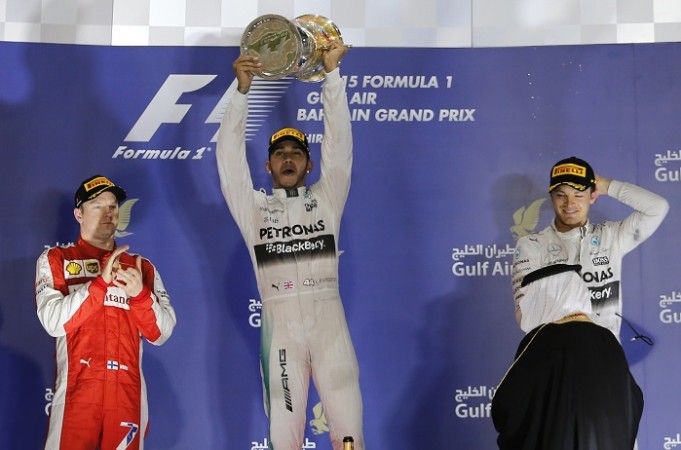 Mercedes driver Lewis Hamilton (C) celebrates next to Ferrari's Kimi Raikkonen (L) and teammate Nico Rosberg following his victory in the Bahrain Grand Prix at Bahrain International Circuit Bahrain Grand Prix