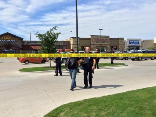 Police escort a man at the scene of a shooting in Waco, Texas, in this handout photo provided by the Waco Police Department on May 17, 2015.