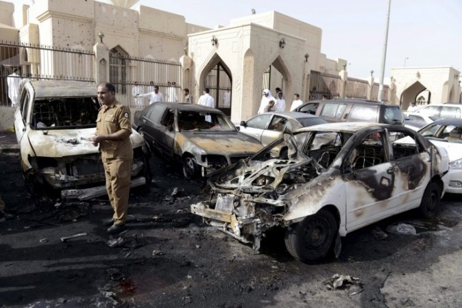 A policeman inspects the site of a car bomb near the Shi'ite al-Anoud mosque in Saudi Arabia's city Dammam