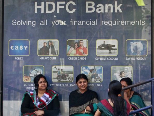 Customers sit outside the branch of a HDFC bank at a shopping arcade in Agartala, capital of India's northeastern state of Tripura, January 20, 2014. HDFC Bank