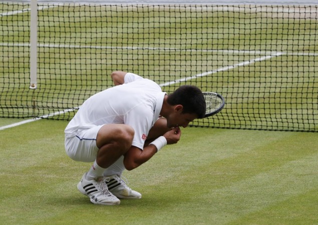 Novak Djokovic eats some of the grass at Centre Court after winning his third Wimbledon title Novak Djokovic Wimbledon 2015 Grass