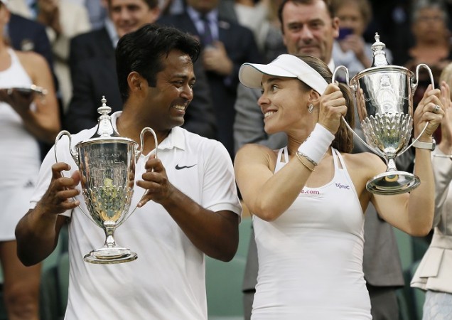 Leander Paes and Martina Hingis hold aloft their Wimbledon mixed doubles trophies proudly after a convincing win in the final Leander Paes Martina Hingis Wimbledon 2015 Trophy