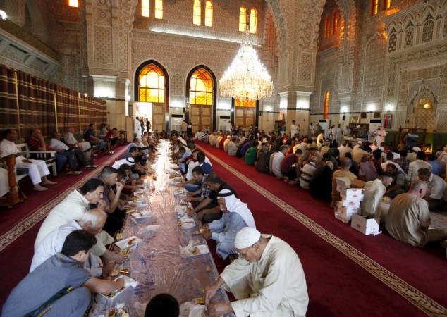 Sunni worshipers eat breakfast after Eid al-Fitr prayers at a mosque in Baghdad. Eid al-Fitr 2015