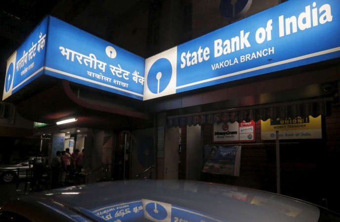 People line up outside an ATM at a State Bank of India branch in Mumbai