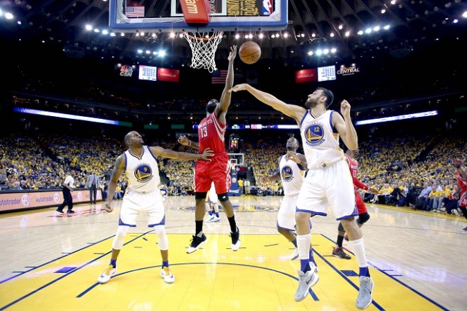 Rockets need to find their feet against Warriors on Thursday. Pictured: James Harden (13) is unable to make a shot between Golden State Warriors guard Andre Iguodala (9) and center Andrew Bogut (12) at Oracle Arena on April 18. Warriors vs Rockets