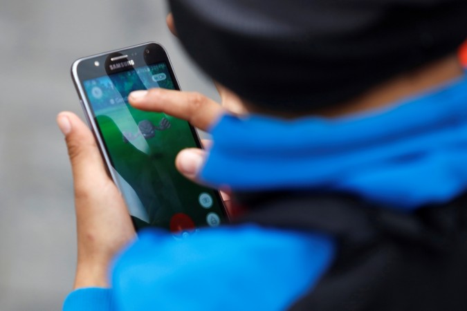 A man plays the augmented reality mobile game