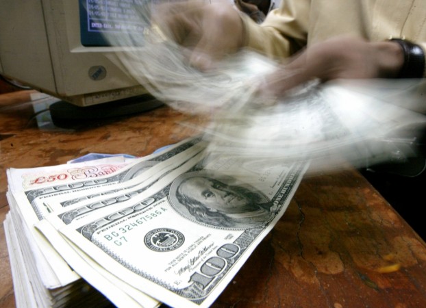A money changer counts U.S. dollars in Mumbai, May 21, 2003 (representational image). india forex reserves rbi foreign exchange dollar buying importers exporters falling rupee value fii stock buying bse debt market