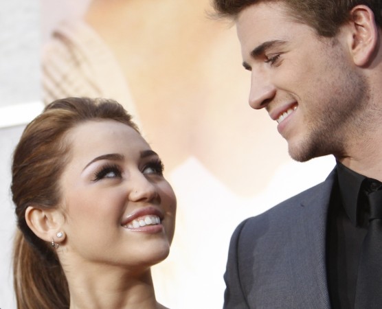 Cast member Miley Cyrus and co-star Liam Hemsworth attend the premiere of Miley Cyrus and Liam Hemsworth