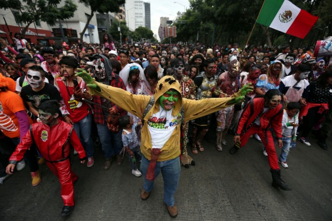 People dressed as zombies participate in a Zombie Walk procession in Mexico City, Mexico, October 22, 2016. Zombie Walk procession
