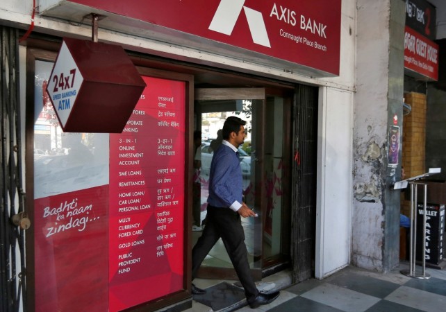 A man leaves an Axis Bank automated teller machine (ATM) in New Delhi, India, October 20, 2016 axis bank, axis bank interest rate on sb deposits, sbi sb deposit rate, banks slash interest rate on