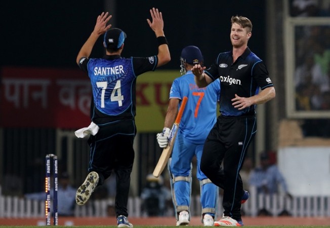 MS Dhoni walks back as Jimmy Neesham celebrates the wicket of the India captain with teammate Mitchell Santner, October 26, 2016 Dhoni India Neesham New Zealand