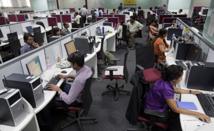 Workers are seen at their workstations on the floor of an outsourcing centre in Bangalore, February 29, 2012. India IT industry
