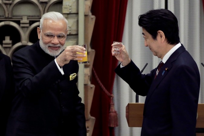 Indian Prime Minister Narendra Modi (L) toasts with his Japanese counterpart Shinzo Abe during a banquet hosted by Abe at the Prime Minister's official residence in Tokyo, Japan November 11, 2016. modi japan visit india trade bilateral agreement tokyo china south china sea dispute territorial row bullet train shinzo abe pm defence ties technology