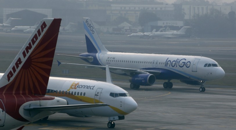 An IndiGo Airlines Airbust A320 aircraft and JetKonnect Boeing 737 aircraft taxi past an Air India Airbus A321 aircraft at Mumbai's Chhatrapathi Shivaji International Airport February 3, 2013. domestic air traffic october indigo vistara air india go air pegasus air costa dgca world jet airways air india plf passengers aviation civil india fastest growing