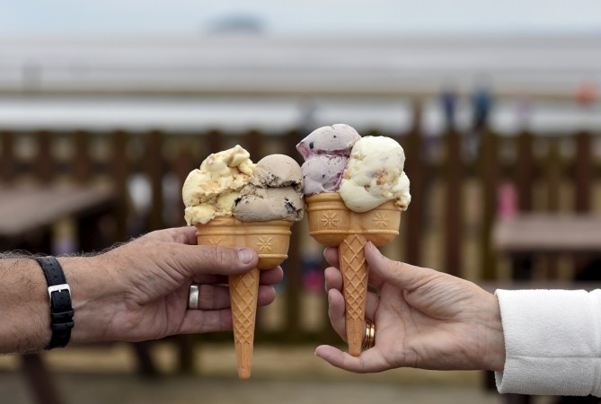 A couple pose with their ice creams on the sea front at Weston Super Mare in south-west England. (Representational Image) ice cream