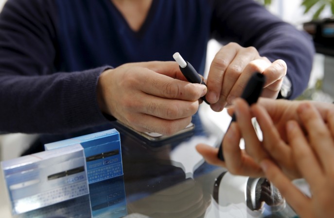 A customer prepares to try a Philip Morris' Philip Morris IQOS