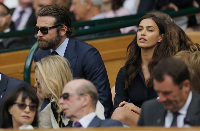 Actor Bradley Cooper and his girlfriend model Irina Shayk in the royal box on centre court at All England Lawn Tennis & Croquet Club, Wimbledon, England. Bradley Cooper and Irina Shayk