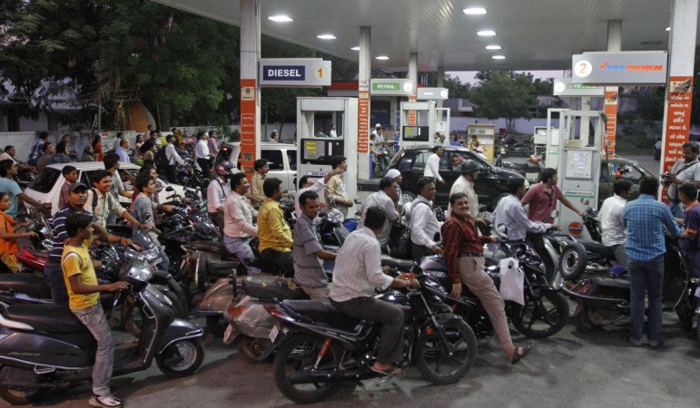 Motorcyclists crowd a fuel station to fill up on petrol in the western Indian city of Ahmedabad. two wheeler sales