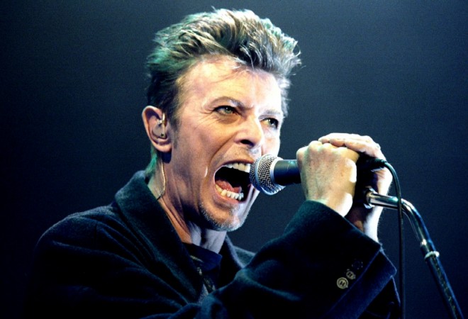 British Pop Star David Bowie screams into the microphone as he performs on stage during his concert in Vienna February 4, 1996. David Bowie