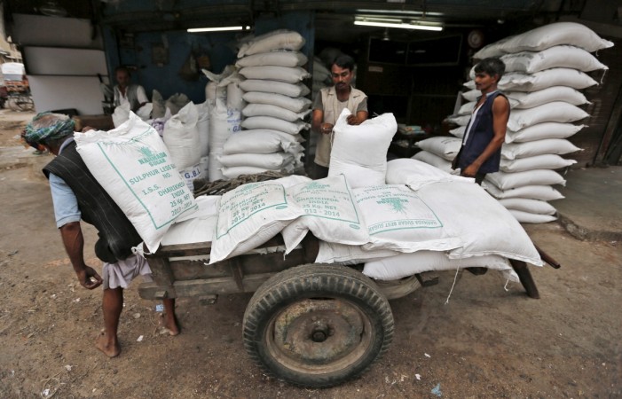 Workers unload sacks containing sugar from a handcart at a wholesale market in Ahmedabad, India, August 5, 2015 (representational image). sugar production india isma estimates crushing consumption demonetisation