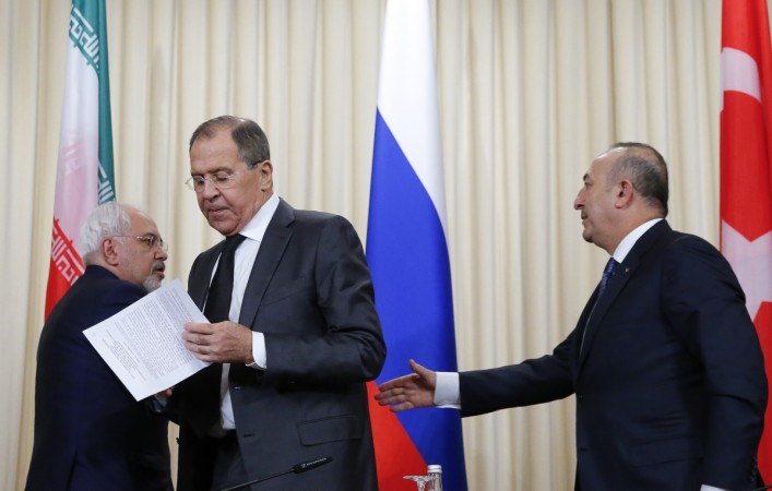 Foreign ministers, Sergei Lavrov (C) of Russia, Mevlut Cavusoglu (R) of Turkey and Mohammad Javad Zarif of Iran, leave after a news conference in Moscow, Russia, December 20, 2016. Syria peace process talks