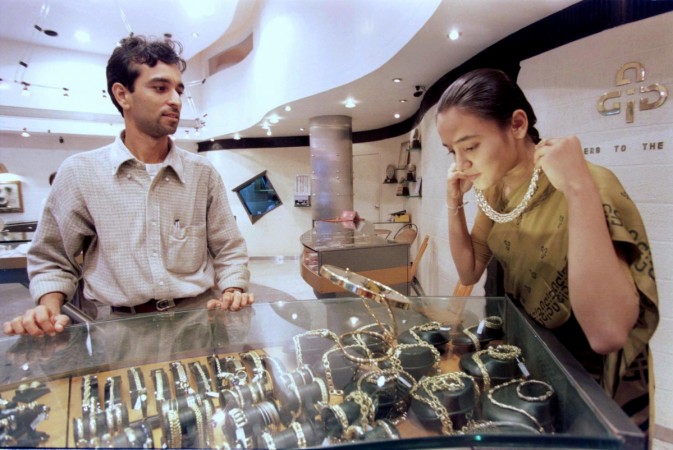 Represtational Image: A customer at a jewellery shop in Bombay tries on a gold necklace gold jewellery