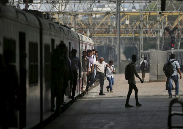 Commuters disembark from a crowded suburban train at Churchgate railway station in Mumbai, India, February 25, 2016. Suburban train commuters offer a big opportunity for the government to drive digital economy, as about 80 lakh of them use trains every year, spending close to Rs 2,000 crore. indian railways, digital india, suresh prabhu, indian economy, modi, railway employees