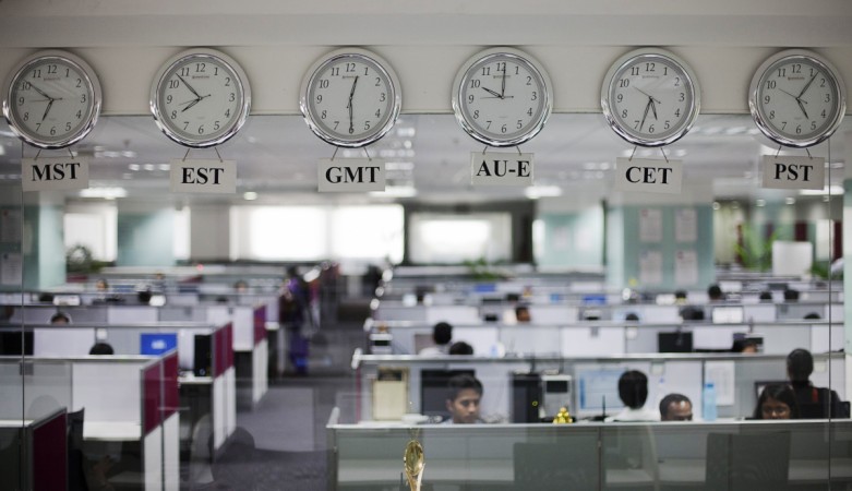 Workers are pictured beneath clocks displaying time zones in various parts of the world at an outsourcing centre in Bangalore, February 29, 2012 (representational image). ramco systems, ramco group, ramco share price, ramco panasonic deal, ramco wins panasonic contract, bse sensex