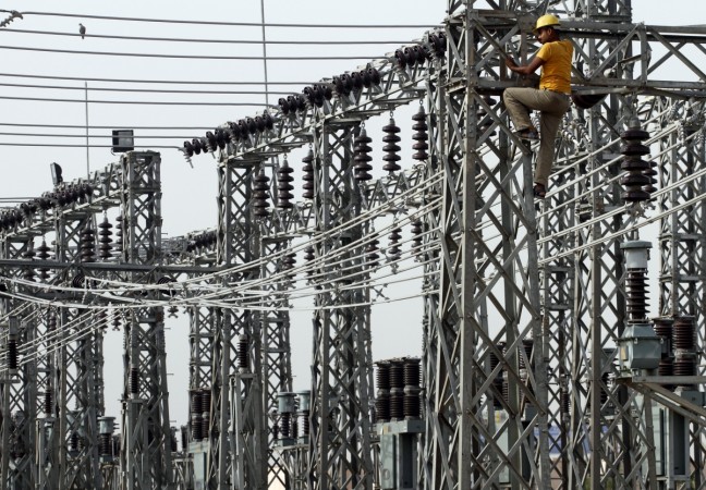 An employee works on electric pylons at a power station in Greater Noida on the outskirts of New Delhi June 8, 2012 (representational image). india electricity, china india relations, china electricity