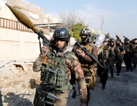 In picture: Iraqi Special Operations Forces (ISOF) carry weapons during clashes with Islamic State militants in frontline near university of Mosul, Iraq, January 13, 2017. ISIS