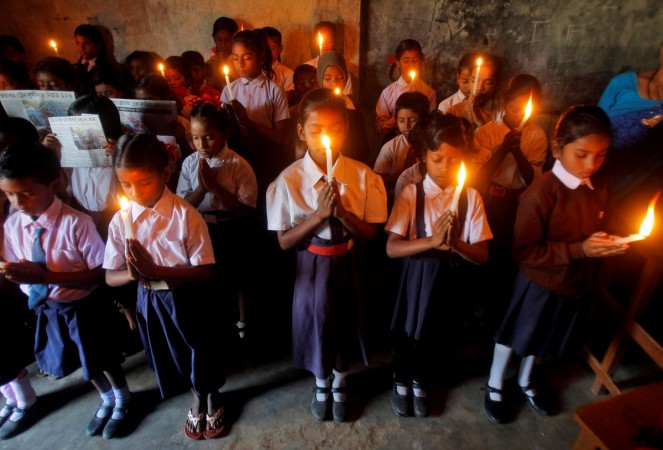 Children hold candles as they pray for the victims of Sunday's train accident at Pukhrayan near Kanpur city, at a school in Agartala, India, November 21, 2016 Train accident