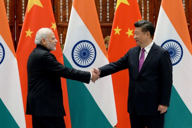 Indian Prime Minister Narendra Modi (L) shakes hands with Chinese President Xi Jinping at the West Lake State Guest House ahead of G20 Summit in Hangzhou, Zhejiang province, China, September 4, 2016 economic survey 2017, survey gdp growth estimate, india china, pm modi, xi jinping, chinese economy, indian economy, bjp, congress, aap