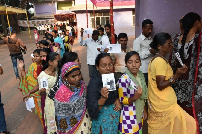 Chimbel: Voters show their voter ID cards as they wait in a queue to cast their vote at a polling booth during Goa Legislative Assembly polls in Chimbel, Goa on Feb 4, 2017. Goa Legislative Assembly polls, Goa Assembly elections, Goa voters