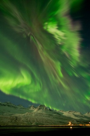 An aurora on March 8, 2012 shimmering over snow-covered mountains in Faskrudsfjordur, Iceland. NASA, Aurora, northern lights, Iceland,